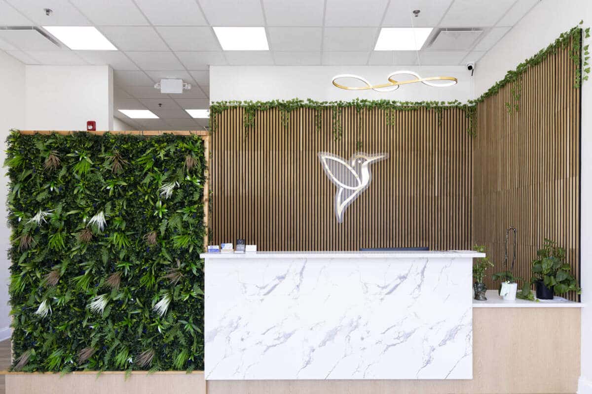 Hummingbird Pediatrics modern office reception area with natural green wall design in Robbinsville NJ