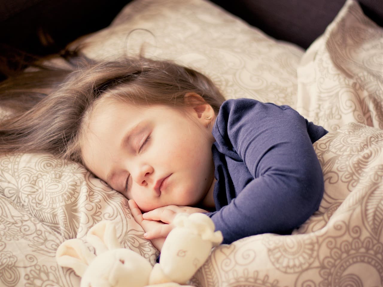 Sick child with high fever being comforted - febrile seizures in children