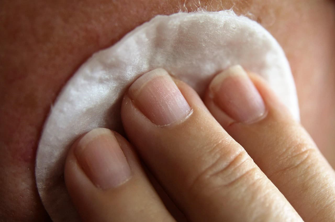 Parent applying moisturizer to child's skin during winter