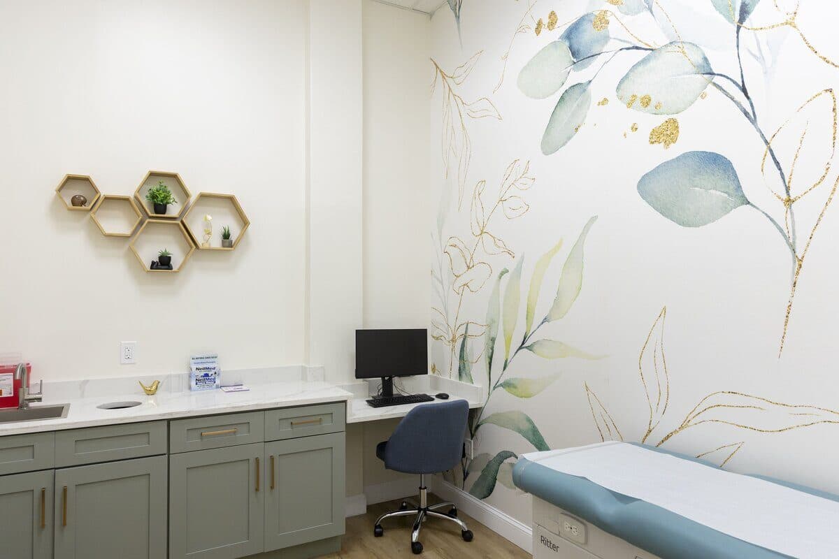 Modern pediatric exam room with soothing botanical wallpaper and state-of-the-art equipment at Hummingbird Pediatrics Hamilton NJ area