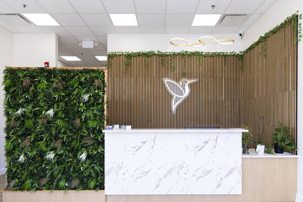 Hummingbird Pediatrics reception desk with living green wall and modern design - pediatric office Robbinsville NJ