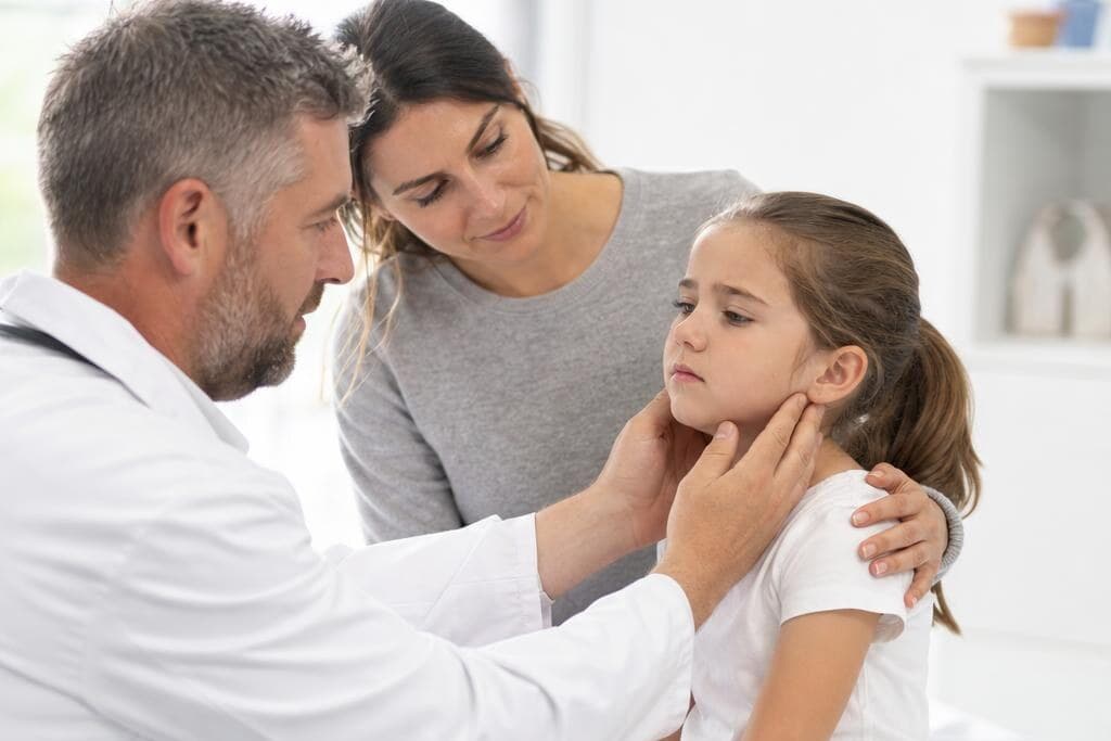 Parent checking child's temperature and looking for signs of serious illness