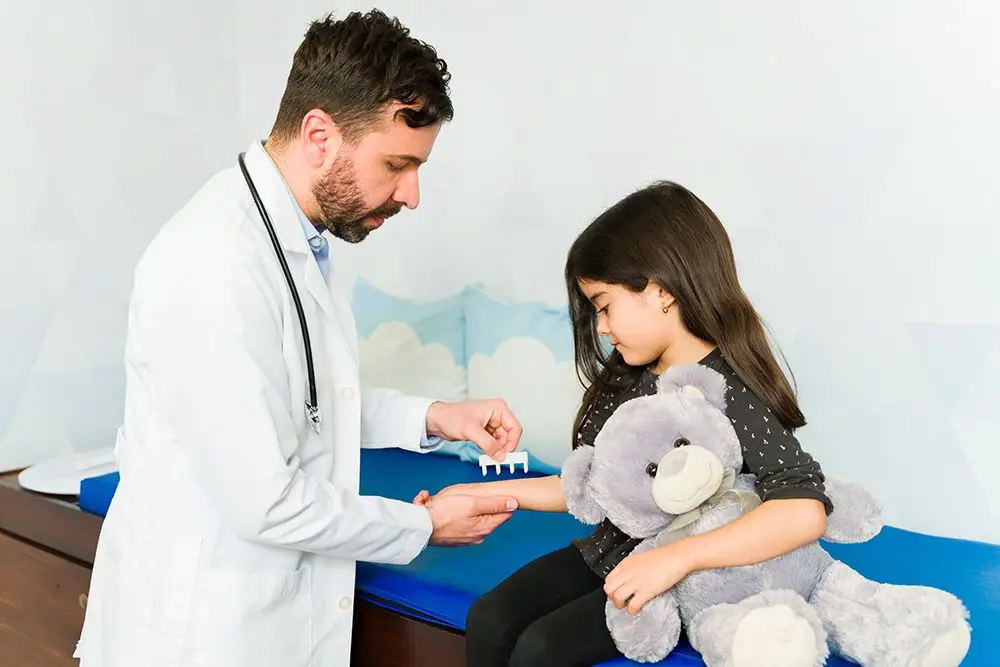 Doctor giving a young girl an allergy test