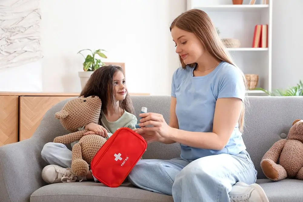 mother pulling inhaler out of first aid bag for her young daughter