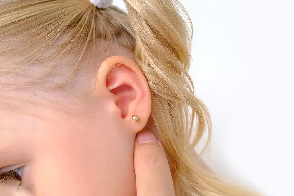 young girl wearing a small earring